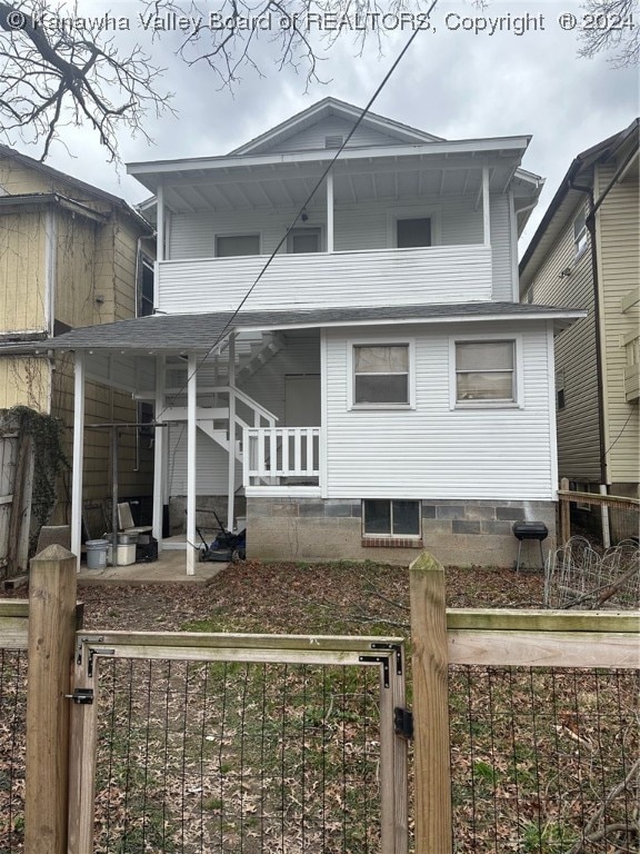 rear view of house featuring a porch