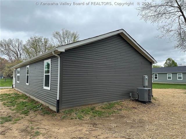 view of side of property featuring central AC