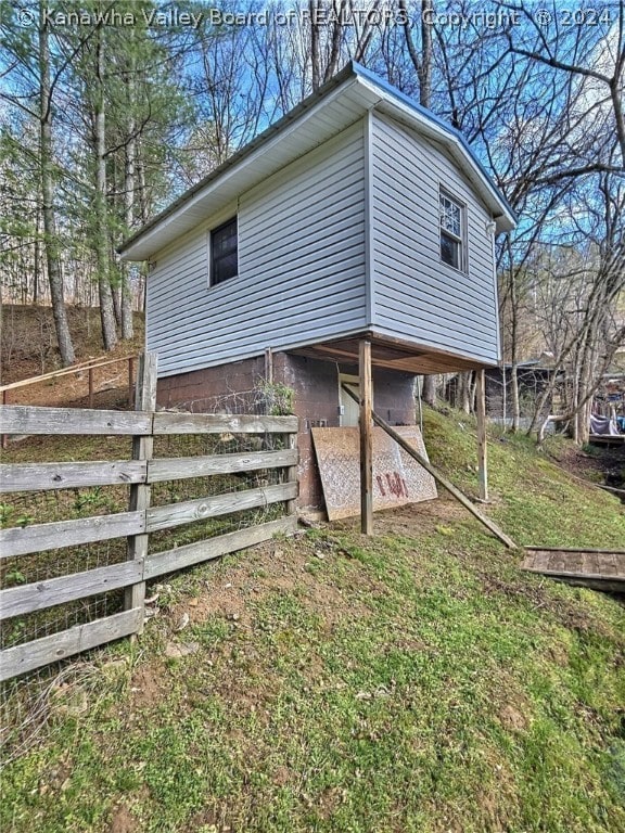 view of property exterior with a lawn