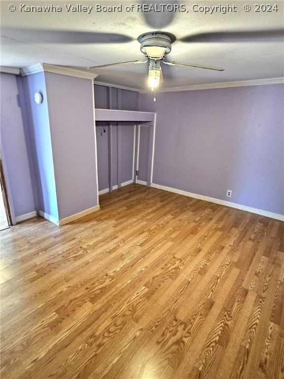 unfurnished bedroom featuring a closet, light hardwood / wood-style floors, ceiling fan, and ornamental molding