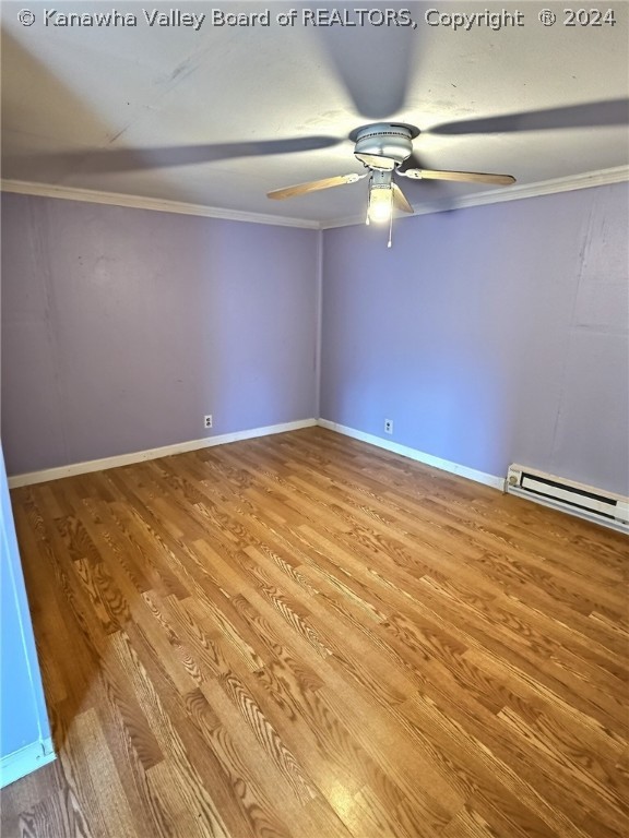 spare room featuring ceiling fan, light hardwood / wood-style flooring, and ornamental molding