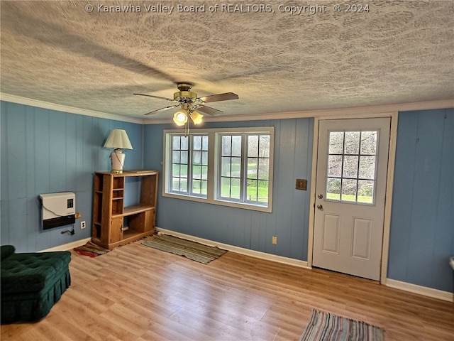 entrance foyer with ceiling fan, light hardwood / wood-style flooring, ornamental molding, and a textured ceiling