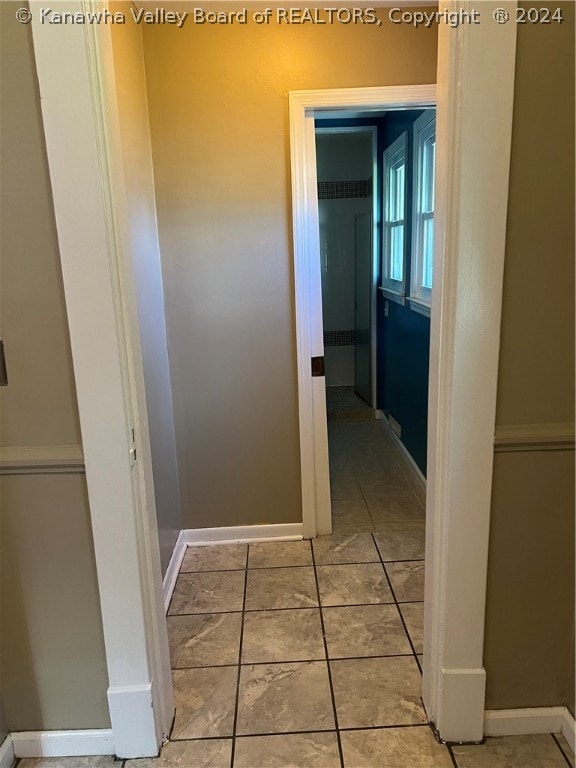 corridor featuring light tile floors