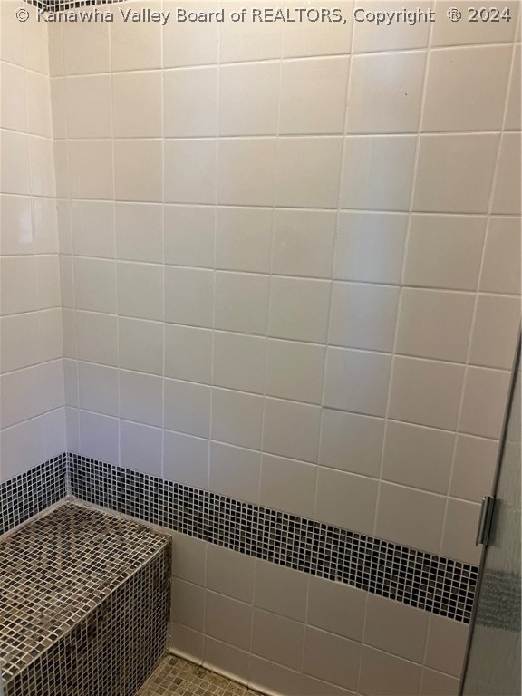 interior space featuring tiled shower