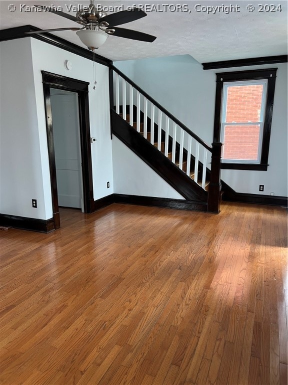 unfurnished room featuring dark hardwood / wood-style flooring and ceiling fan