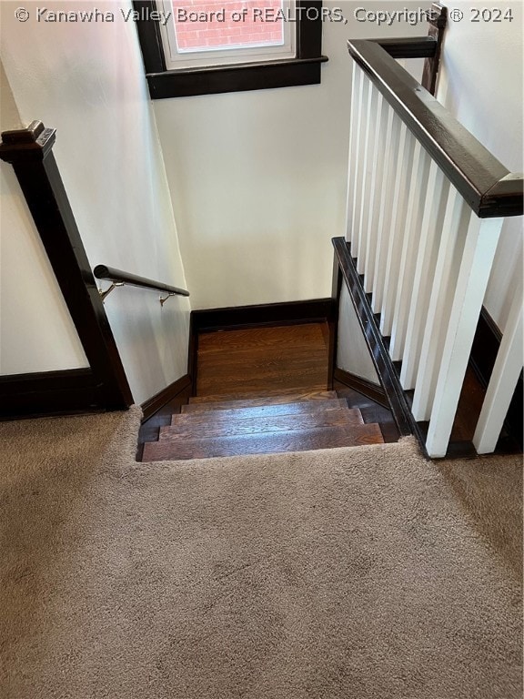 stairway featuring dark hardwood / wood-style floors