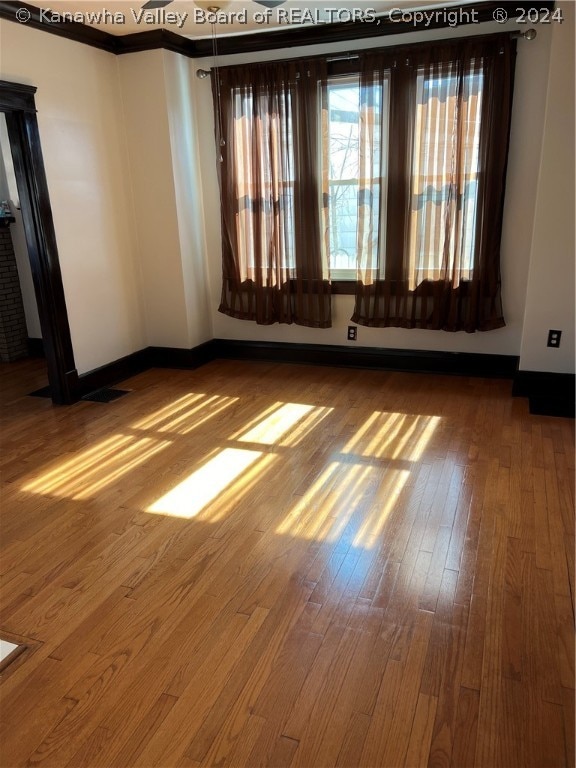 spare room with dark hardwood / wood-style floors