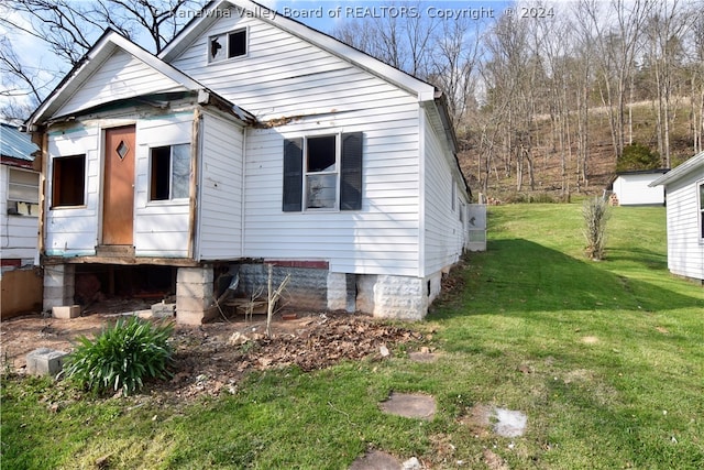 view of property exterior with a lawn