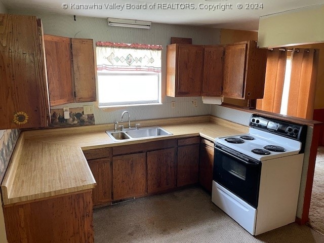 kitchen featuring kitchen peninsula, white range with electric cooktop, light carpet, and sink