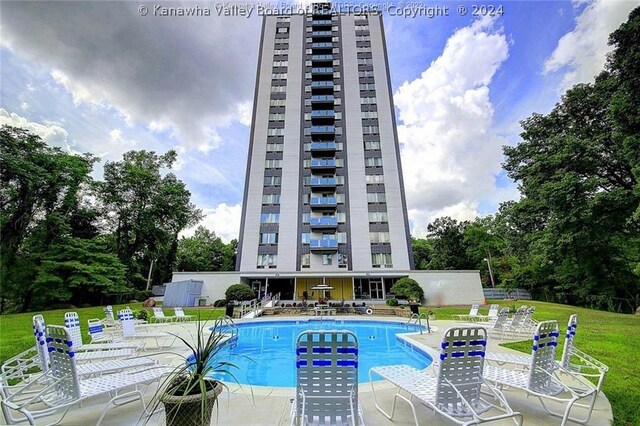 view of swimming pool with a yard