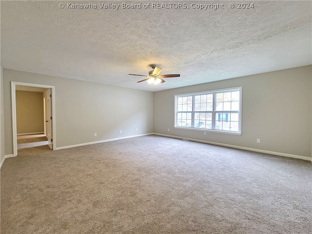 unfurnished room with a textured ceiling, ceiling fan, and carpet