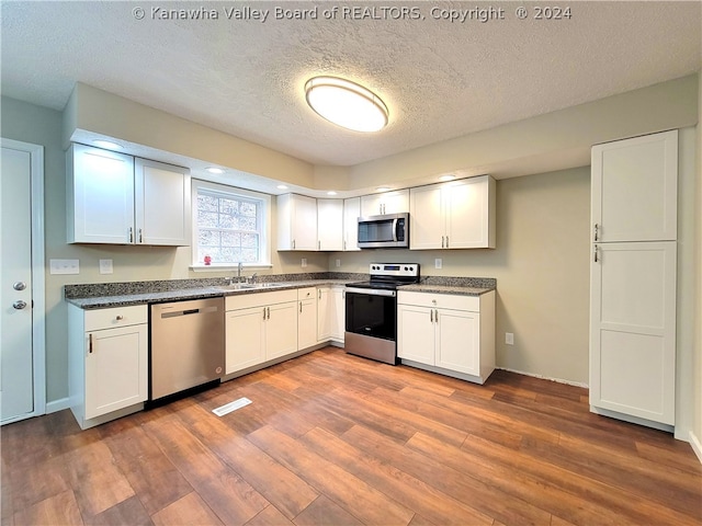 kitchen featuring stainless steel appliances, sink, and white cabinets