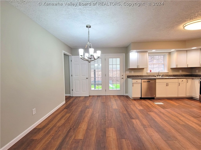 kitchen with an inviting chandelier, hanging light fixtures, stainless steel dishwasher, and white cabinets