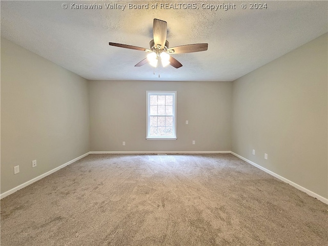 carpeted spare room with ceiling fan and a textured ceiling