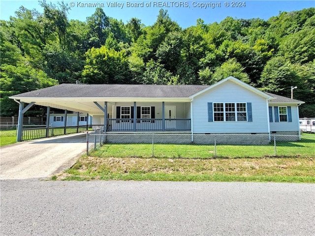 view of front of property with a carport, covered porch, and a front lawn