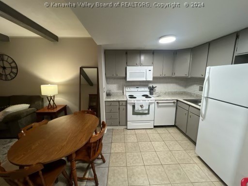 kitchen with white appliances, tasteful backsplash, and gray cabinetry