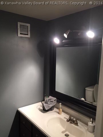 bathroom with oversized vanity and toilet