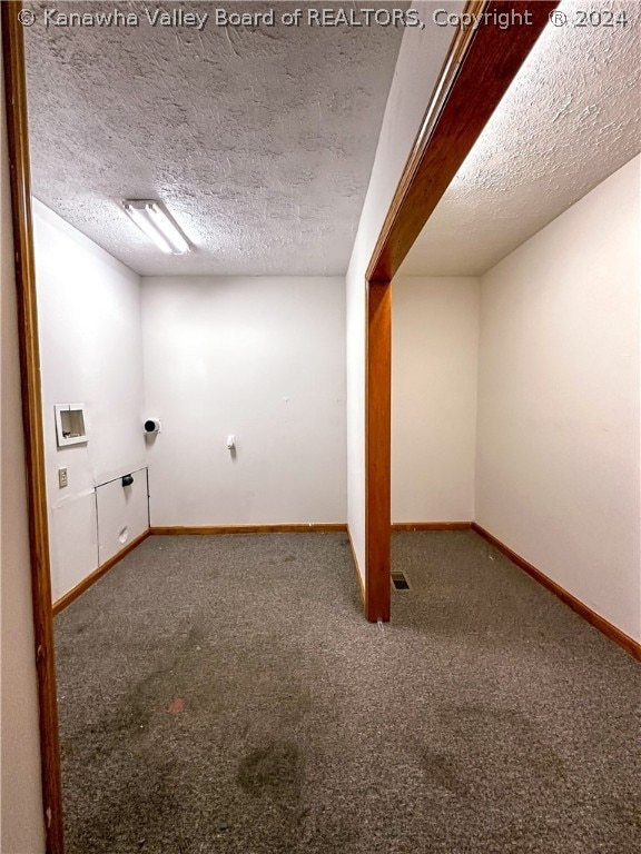 basement featuring carpet and a textured ceiling