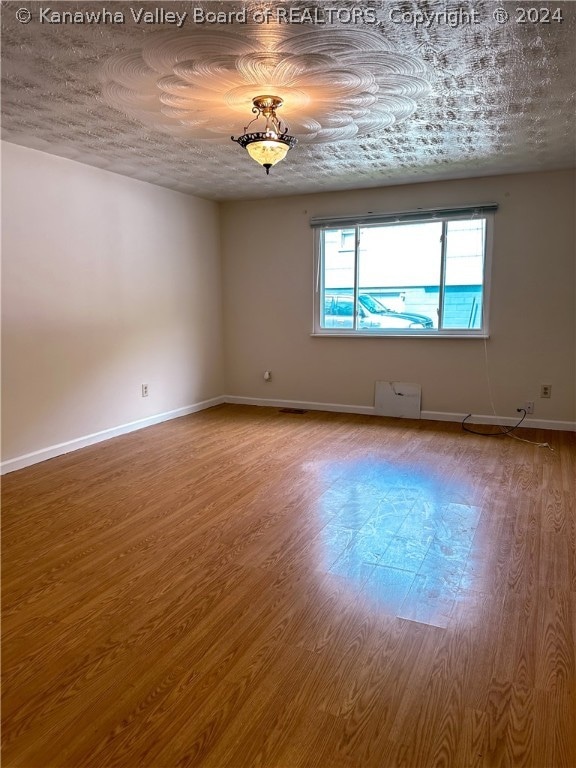 spare room with hardwood / wood-style flooring