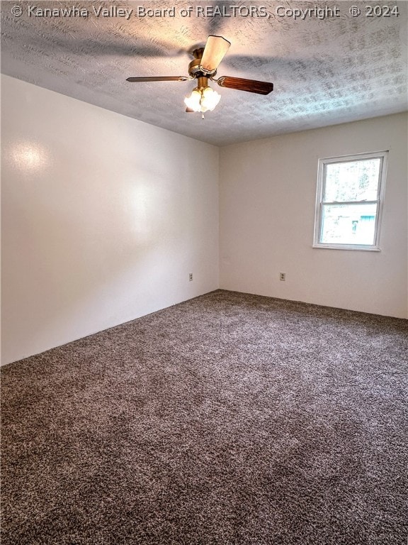 empty room with a textured ceiling, carpet floors, and ceiling fan