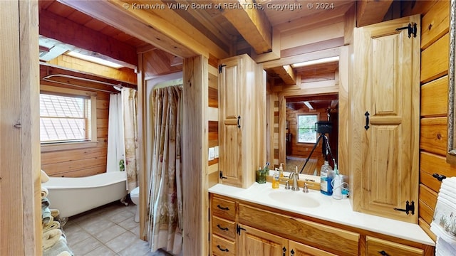 bathroom featuring tile flooring, beam ceiling, wood walls, wood ceiling, and vanity