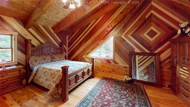 bedroom with lofted ceiling with beams, light hardwood / wood-style floors, wood walls, and wooden ceiling