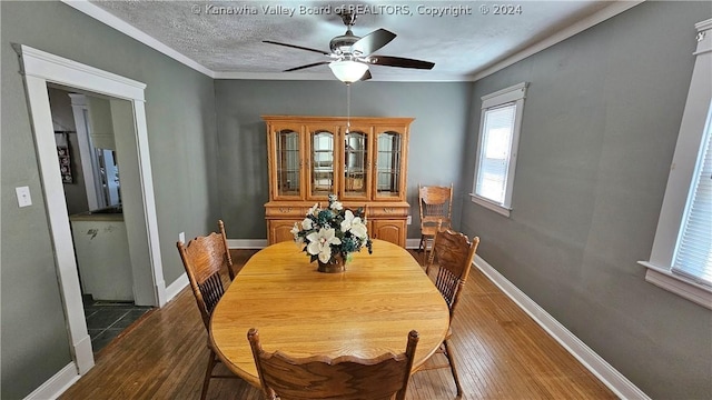 dining area with hardwood / wood-style floors, ceiling fan, crown molding, and a textured ceiling