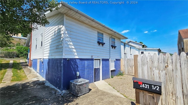 view of side of home with cooling unit