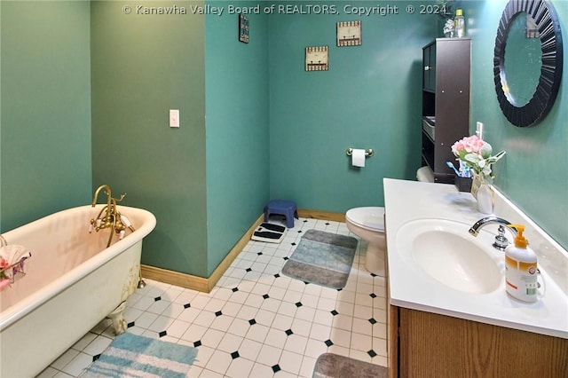 bathroom featuring vanity, toilet, and a tub