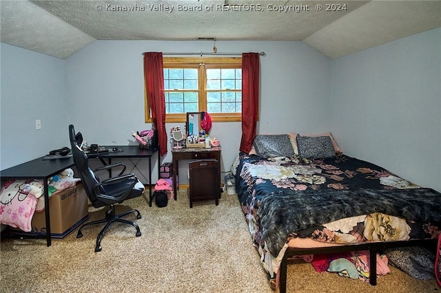 carpeted bedroom featuring vaulted ceiling and a textured ceiling