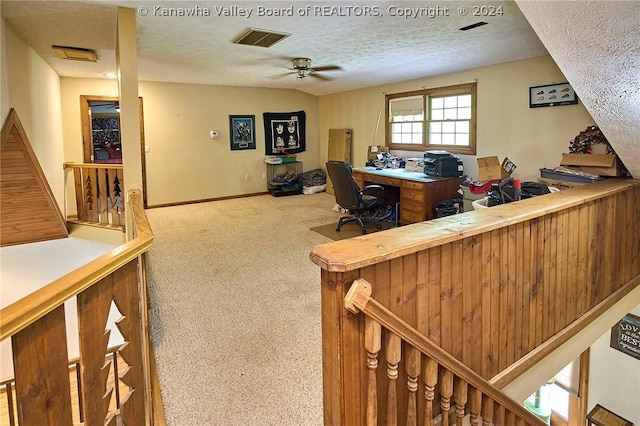 carpeted office with ceiling fan and a textured ceiling