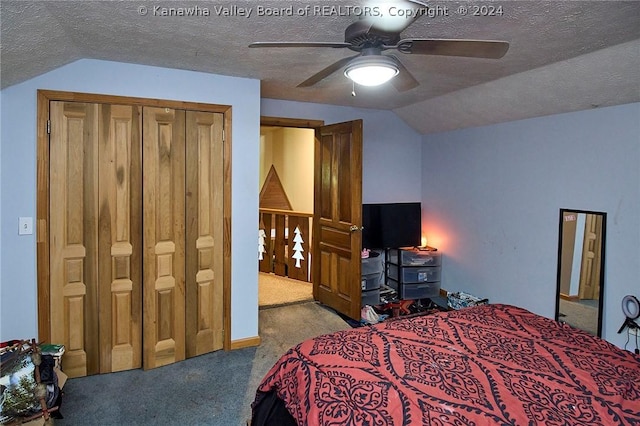 bedroom featuring ceiling fan, carpet, a textured ceiling, vaulted ceiling, and a closet