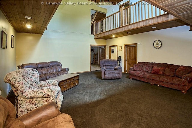 living room with wooden ceiling, a high ceiling, and carpet