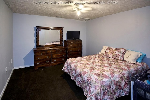 bedroom featuring dark colored carpet, ceiling fan, and a textured ceiling