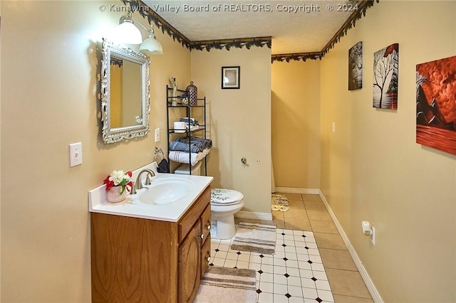 bathroom with vanity, tile patterned floors, a textured ceiling, and toilet