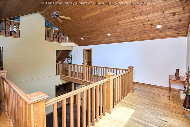 hallway featuring high vaulted ceiling, wooden ceiling, and light wood-type flooring