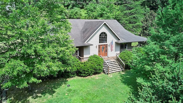 view of front facade with a wooden deck and a front lawn