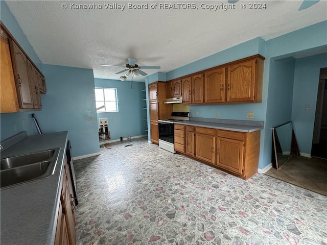 kitchen featuring white range with electric stovetop, ceiling fan, sink, and a textured ceiling