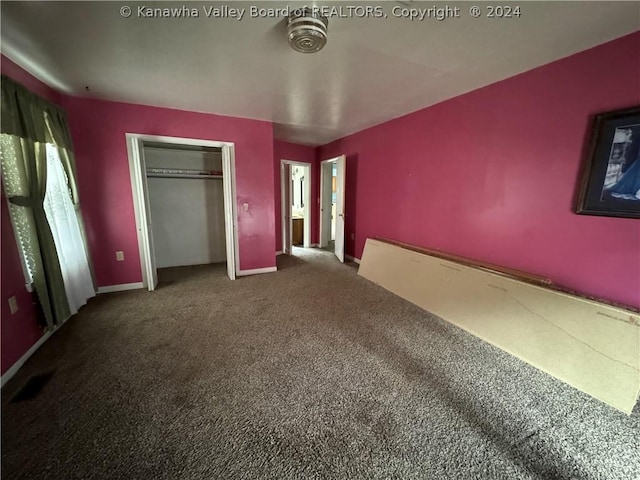 unfurnished bedroom with carpet floors and a closet