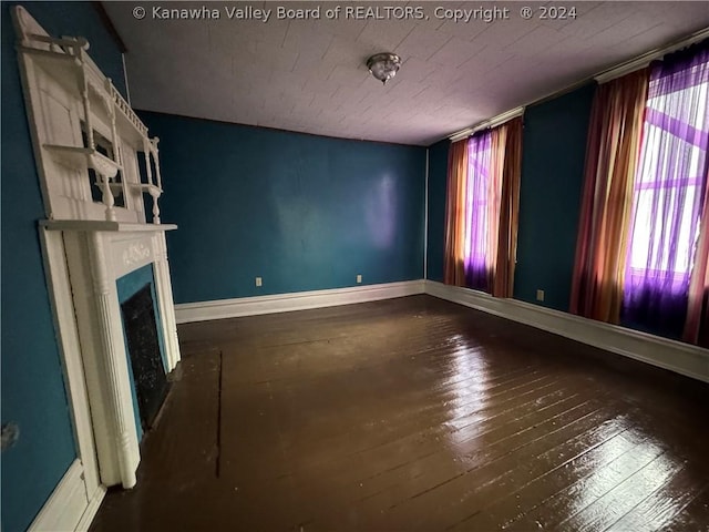 unfurnished living room with dark hardwood / wood-style flooring