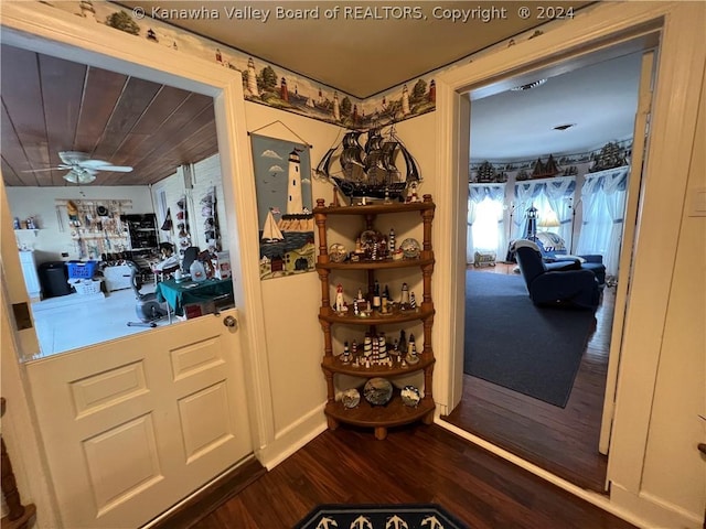 doorway to outside featuring dark wood-type flooring and ceiling fan