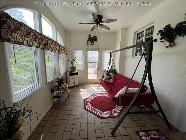 sunroom / solarium featuring ceiling fan and plenty of natural light