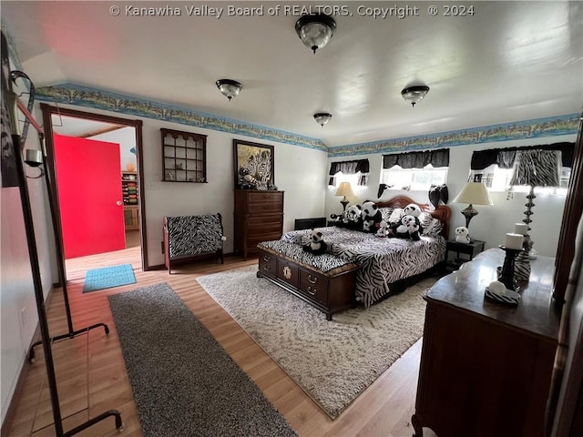 bedroom with hardwood / wood-style flooring