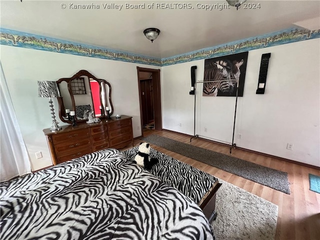 bedroom with wood-type flooring