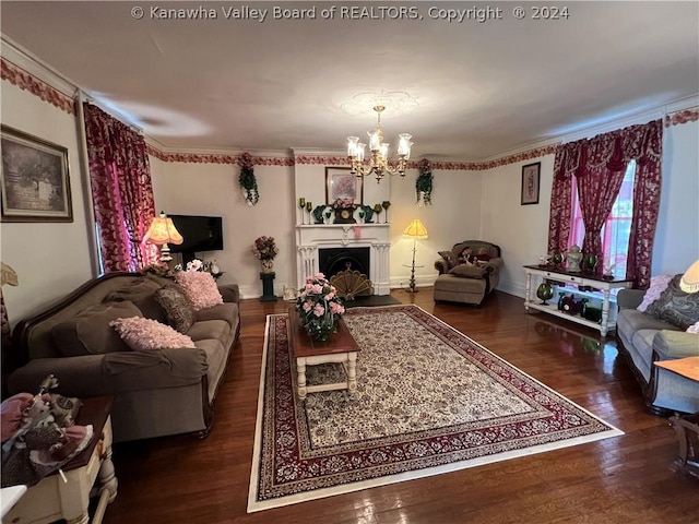 living room with dark hardwood / wood-style flooring, ornamental molding, and an inviting chandelier