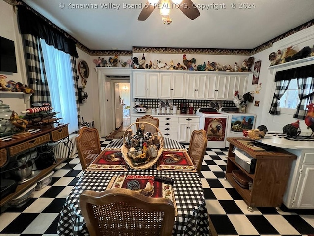 dining room featuring a healthy amount of sunlight, ceiling fan, and washing machine and clothes dryer