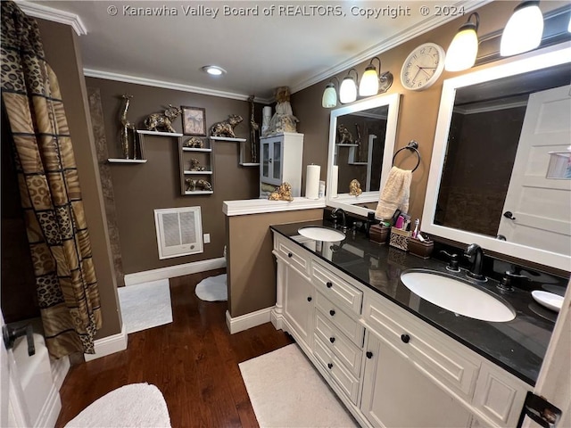 bathroom with crown molding, vanity, and hardwood / wood-style flooring