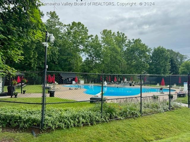 view of pool featuring a lawn