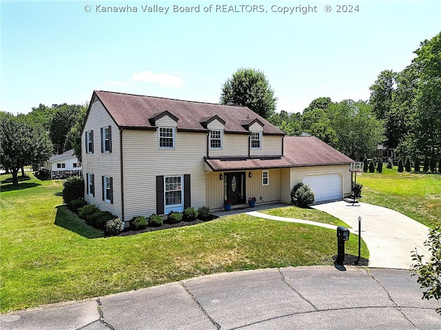 view of front of property featuring a front yard and a garage