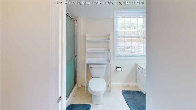 bathroom featuring tile patterned floors, vanity, toilet, and an enclosed shower